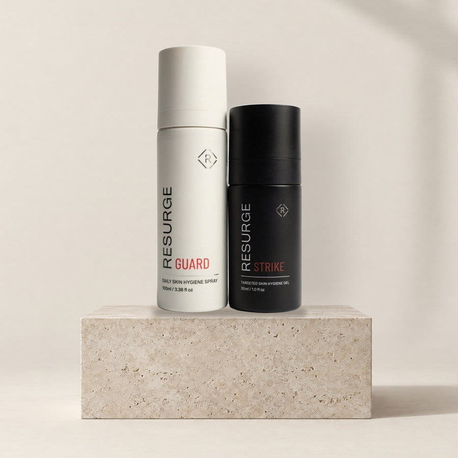 Resurge Combat Kit: GUARD daily skin hygiene spray 100ml and STRIKE targeted skin hygiene gel 30ml on a stone plinth